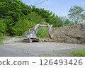 A rusty hydraulic excavator in a vacant lot 126493426