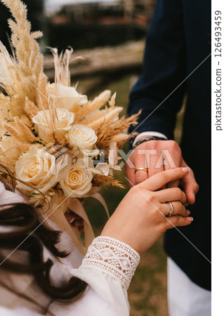 Wedding Ceremony Close-Up: Exchanging Rings and Bouquet 126493459