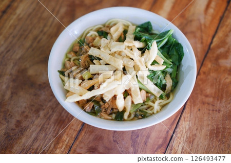 Fried noodle in white bowl on wooden table Fried noodle in white bowl on wooden table 126493477