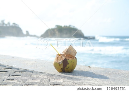 Coconut drink on a beach with ocean view Coconut drink on a beach with ocean view 126493761