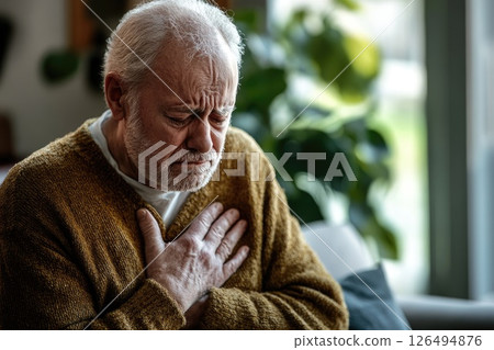Senior Man Suffering from Heart Attack in Modern Living Room, Emergency Contact Space Available 126494876