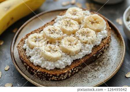 A plate of toast with bananas and cheese on top 126495042