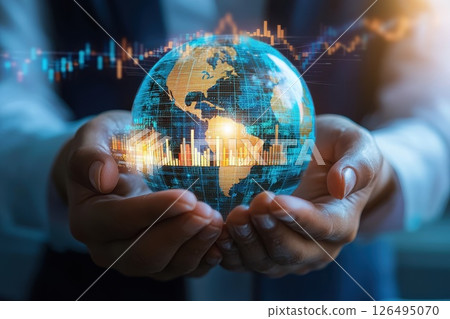 A person is holding a globe with a computer screen behind it A person is holding a globe with a computer screen behind it 126495070