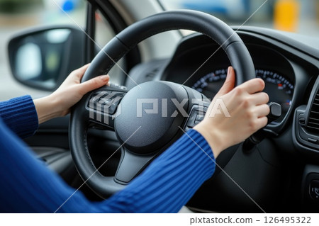 A woman is driving a car with a dirty steering wheel A woman is driving a car with a dirty steering wheel 126495322
