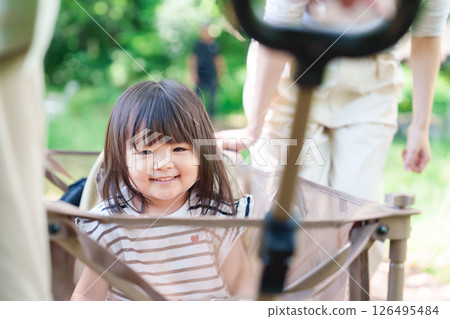 A little girl happy to ride in a cart 126495484