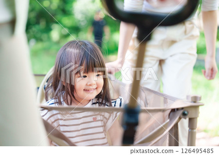 A little girl happy to ride in a cart 126495485