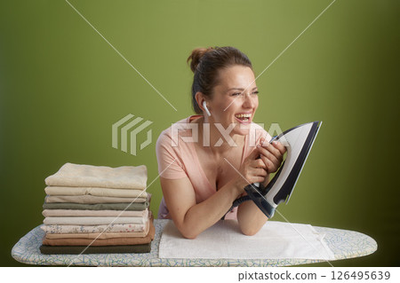 Laughing while ironing: Joyful chore time Laughing while ironing: Joyful chore time 126495639