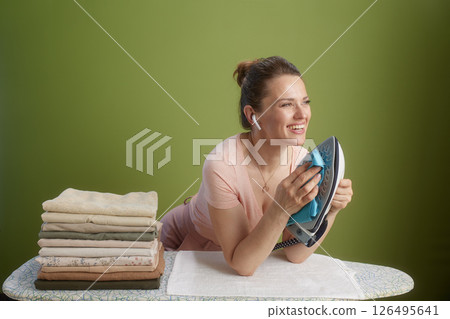 Content woman cleaning iron, pink shirt & peach skirt Content woman cleaning iron, pink shirt & peach skirt 126495641
