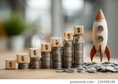 Startup Founder Launching Tiny Rocket Surrounded by Coins and Money Stacked on the Table Startup Founder Launching Tiny Rocket Surrounded by Coins and Money Stacked on the Table 126496196