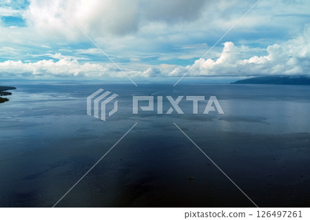 Drone view of sea and clouds, tropical strait in Philippines, boat on water, scenic seascape 126497261