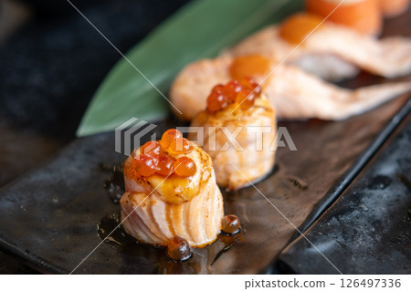 Ikura with grilled Salmon Roll served on plate 126497336