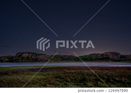 A spectacular night view of a star-filled sky, a quiet lakeside, and mountains A spectacular night view of a star-filled sky, a quiet lakeside, and mountains 126497890