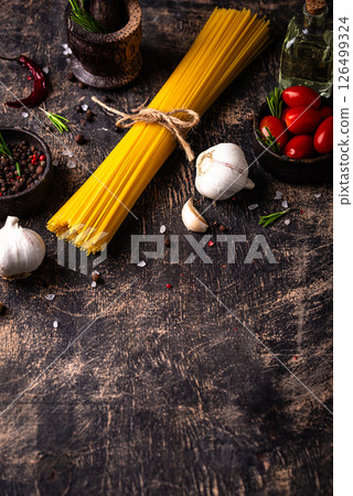 Italian food background with spaghetti, tomato and spices Italian food background with spaghetti, tomato and spices 126499324