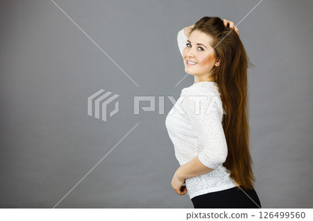 Happy positive woman with long brown hair 126499560
