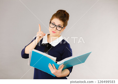 Happy positive business woman holding binder with documents 126499583
