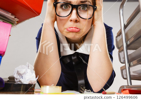 Depressed businesswoman sitting at desk 126499606