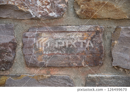 Textural stone wall from an old brick of the architectural building. 126499670