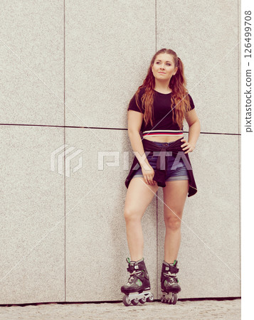 Young woman riding roller skates Young woman riding roller skates 126499708