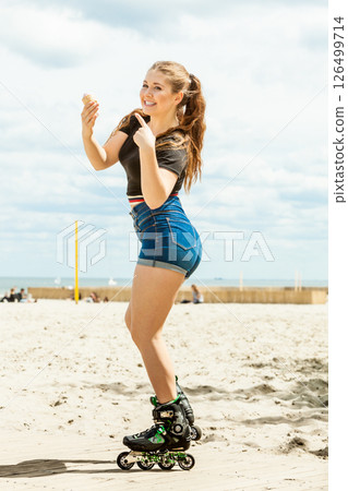 Roller skate woman eating ice cream Roller skate woman eating ice cream 126499714