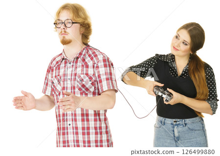 Woman controling man using gaming pad Woman controling man using gaming pad 126499880