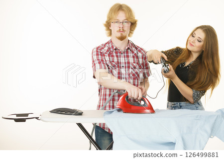 Woman controling man to do ironing 126499881