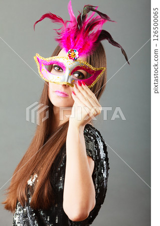 woman face with carnival mask on gray 126500065