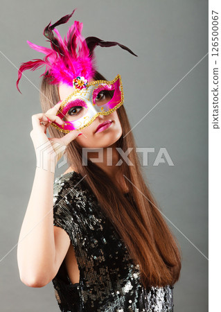 woman face with carnival mask on gray 126500067