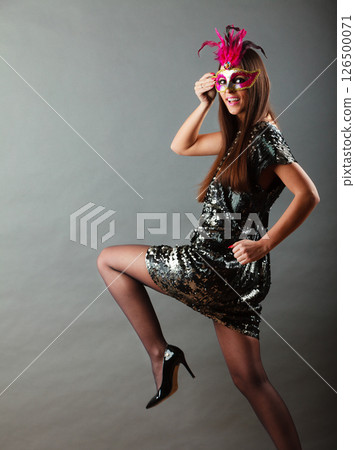 woman with carnival mask on gray woman with carnival mask on gray 126500071