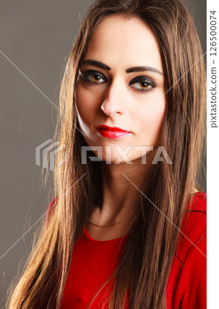 woman long straight hair dark makeup red lips on gray woman long straight hair dark makeup red lips on gray 126500074
