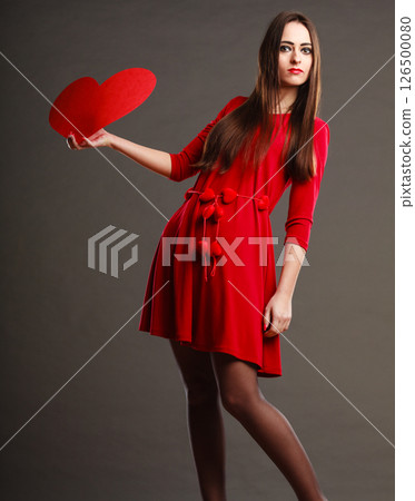Girl holding red heart love sign 126500080