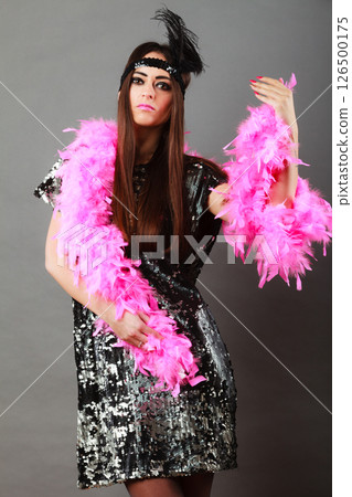 Girl pink plume and black feather on head. Carnival. 126500175