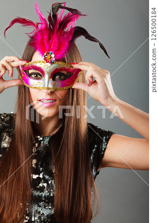 woman face with carnival mask on gray woman face with carnival mask on gray 126500184