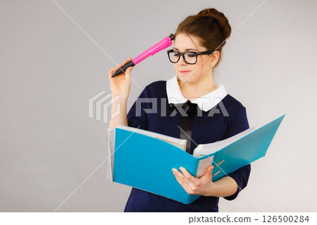 woman thinking holds file folder with documents woman thinking holds file folder with documents 126500284