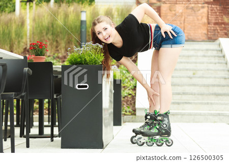 Young woman riding roller skates Young woman riding roller skates 126500305