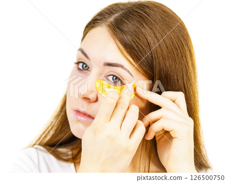 Woman with gold patches under eyes Woman with gold patches under eyes 126500750