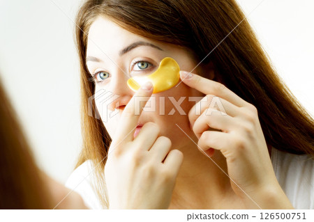 Woman with gold patches under eyes Woman with gold patches under eyes 126500751