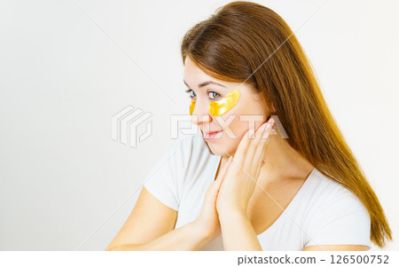 Woman with gold patches under eyes 126500752