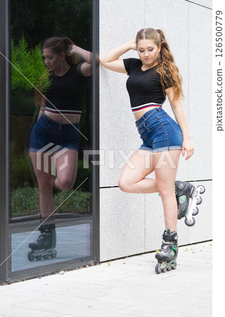 Young woman riding roller skates Young woman riding roller skates 126500779