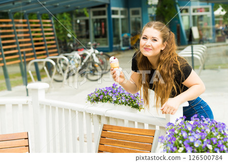 Young woman eating ice cream 126500784