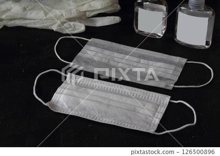 A wedding ring on a medical face mask. Divorce and marriage separation during the Coronavirus A wedding ring on a medical face mask. Divorce and marriage separation during the Coronavirus 126500896