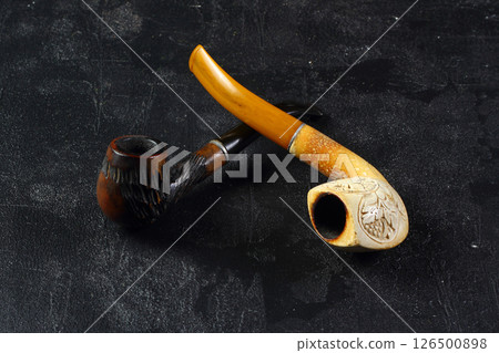 Smoking pipe wooden souvenir isolated black background Smoking pipe wooden souvenir isolated black background 126500898