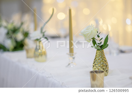 wedding table with exclusive floral arrangement prepared for reception, wedding or event centerpiece in greenery style 126500995