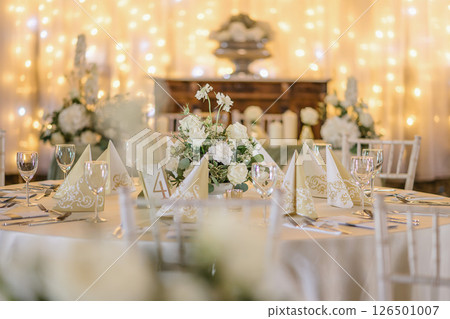 wedding table with exclusive floral arrangement prepared for reception, wedding or event centerpiece in greenery style 126501007