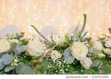 wedding table with exclusive floral arrangement prepared for reception, wedding or event centerpiece in greenery style 126501009