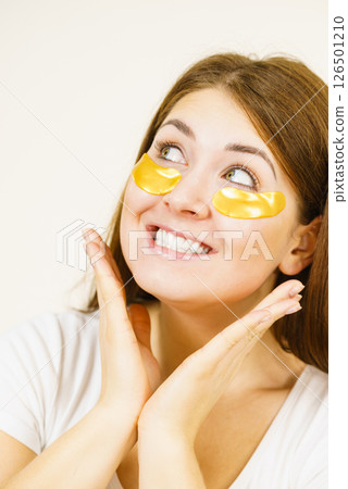 Woman with gold patches under eyes 126501210