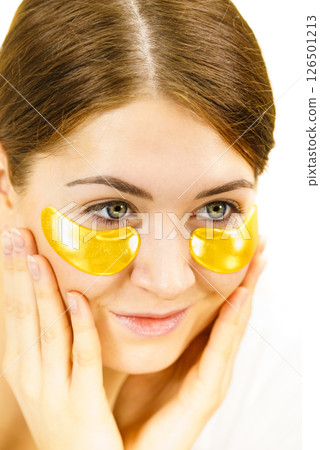 Woman with gold patches under eyes Woman with gold patches under eyes 126501213