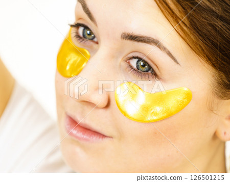 Woman with gold patches under eyes Woman with gold patches under eyes 126501215
