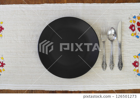 Empty black slate plate on dark stone table. Food background for menu, recipe. Table setting. Empty black slate plate on dark stone table. Food background for menu, recipe. Table setting. 126501273