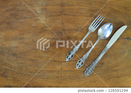 Overhead shot of silverware on wooden table with copy space. Overhead shot of silverware on wooden table with copy space. 126501294