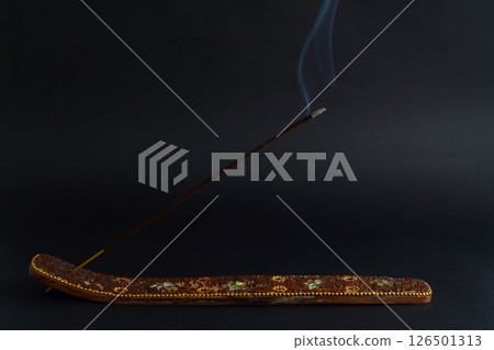 Incense stick are burning and smoke on black background. Incense stick are burning and smoke on black background. 126501313
